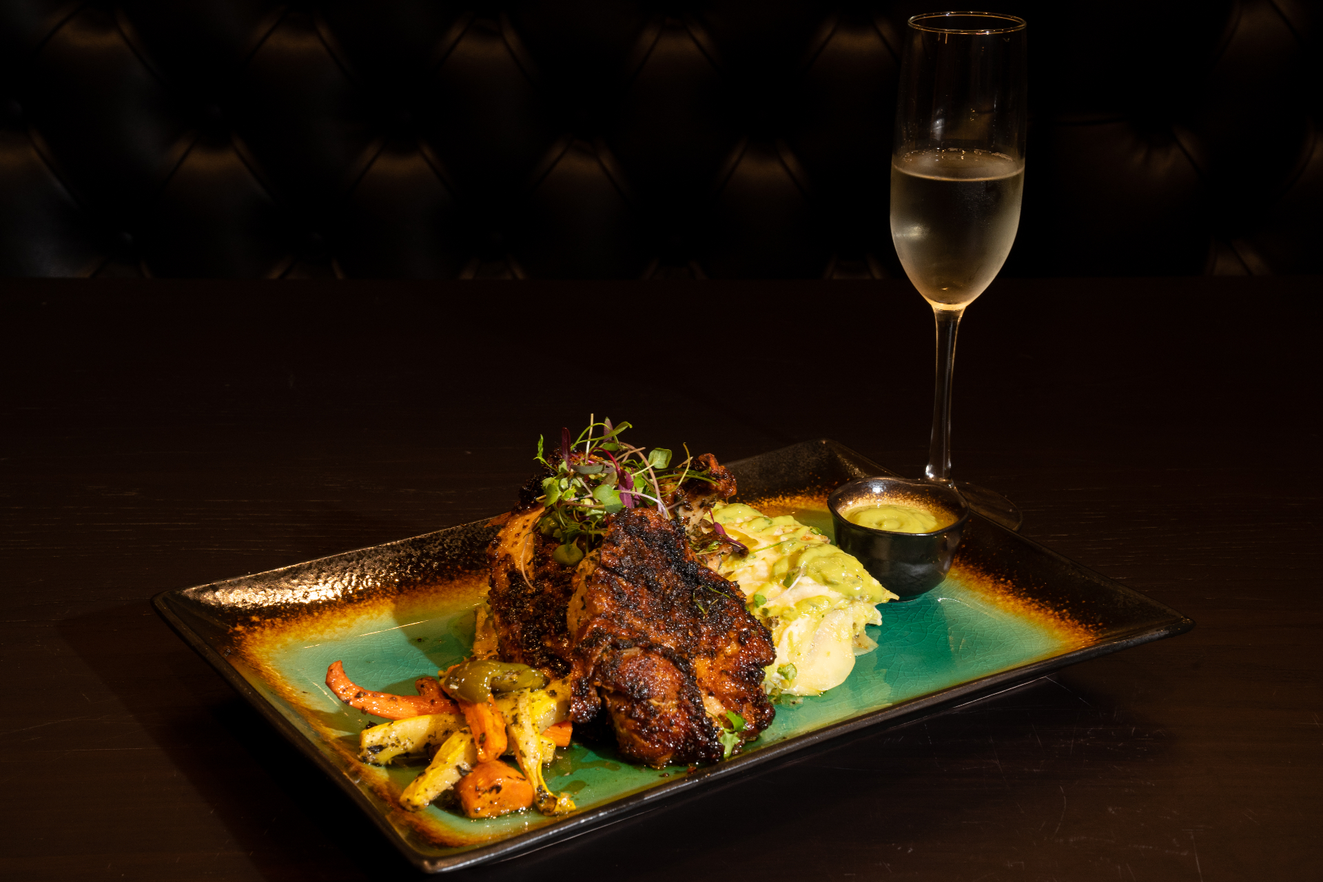 Chef entree with vegetables, creamy pasta, and sparkling wine